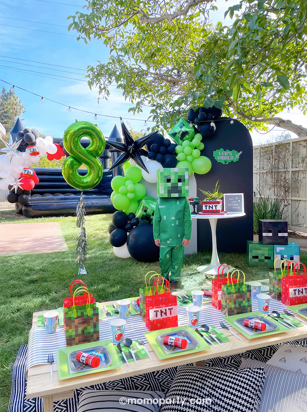 Minecraft themed Birthday Party Ideas by Momopartys. Party-set-up with birthday boy wearing creeper costume