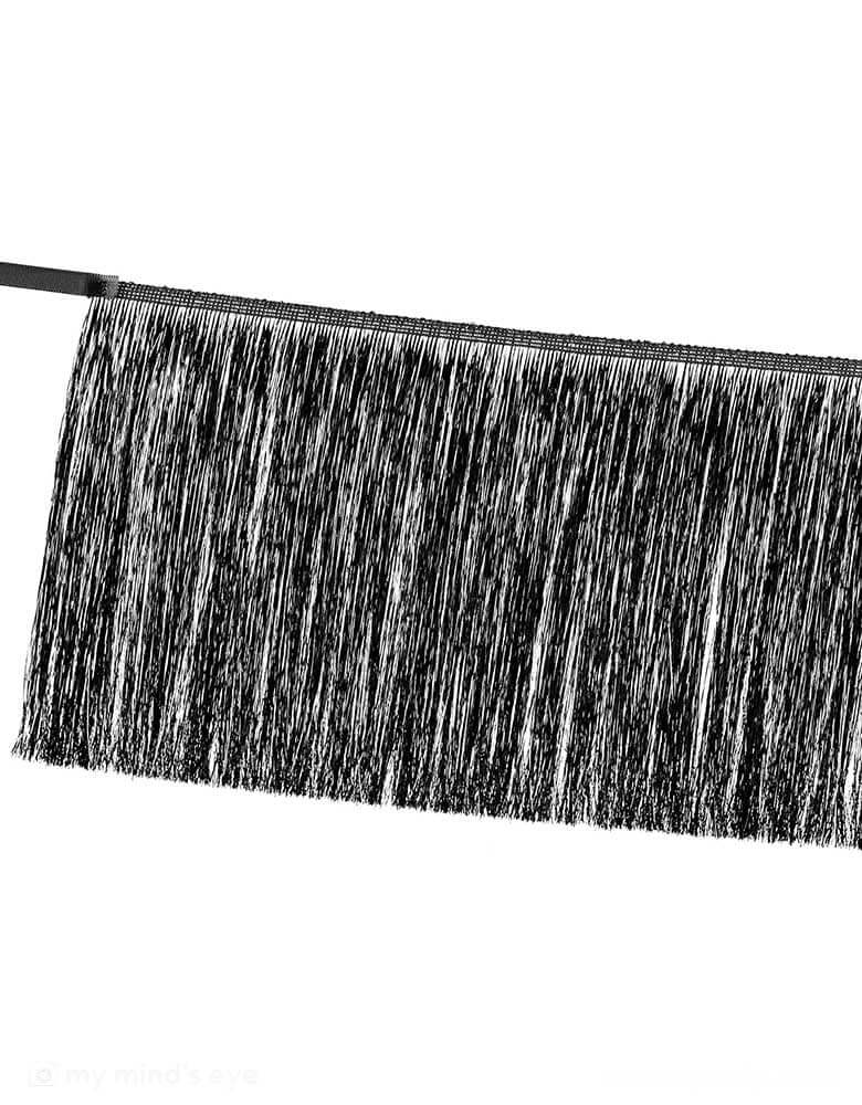 A close up of Momopartys's 4.43ft Black Tinsel Fringe Garland by Party Deco. Simply hang up for instant style. Add this to your Halloween bash or New Year party this season for extra festivity!