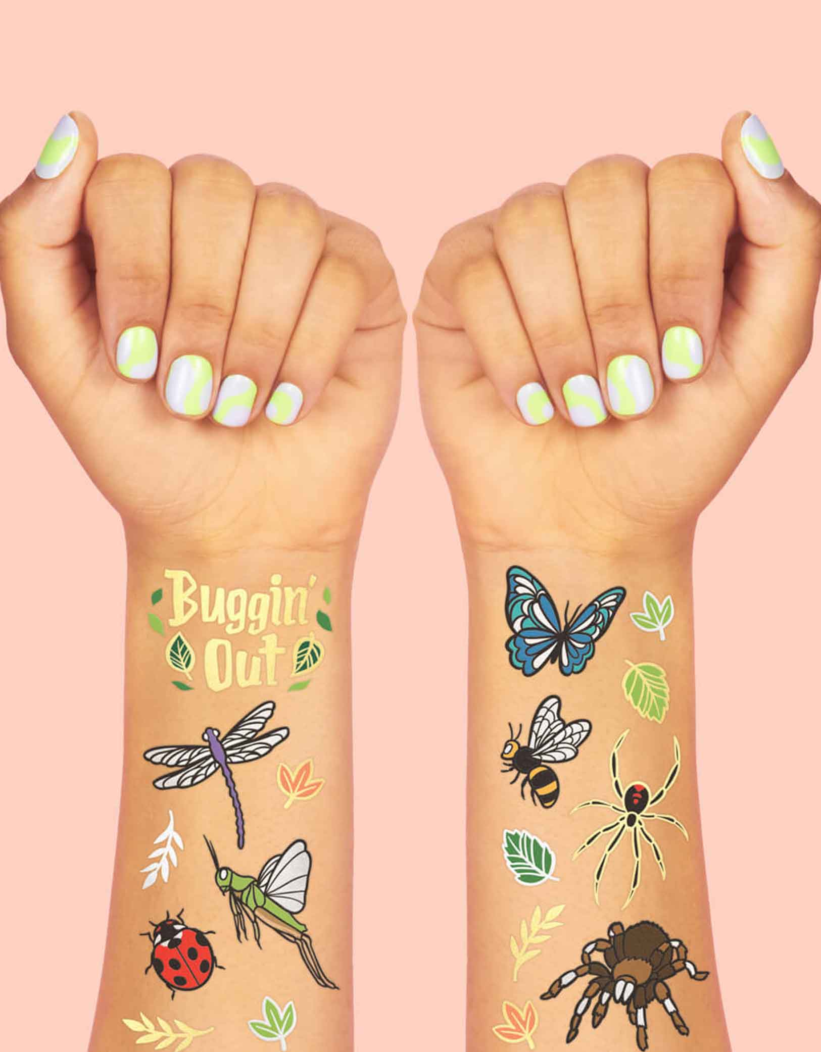 Two arms decorated with Momopartys's Bugs Foil Temporary Tattoos by Xo, Fetti. Comes with 48 tattoos in designs of insects, bugs, butterflies, leaves, and spiders, they're perfect for kid's insect bug themed birthday parties. So call your bug-loving kids, they're going to want to buzz, hop, and fly over fast for these temporary tattoos at their celebration.