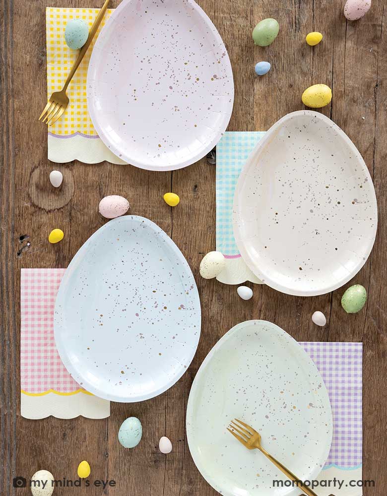 An Easter tableset feature Momopartys's 7" x 9" Easter egg shaped plates in four different pastel colors of pink, ivory, blue and green, each pairs with pastel gingham checkered guest napkins in 4 different colors of yellow, blue, yellow and purple with scallop edges. With mini Easter egg candies scattered around the table, making this an elegant yet stylish tablescape inspo this Easter.
