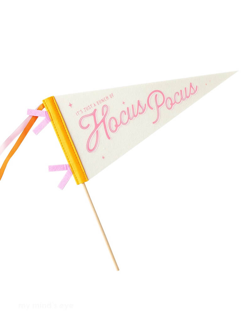 Momo Party's Hocus Pocus Felt Pennant by My Mind's Eye. Comes in orange and pink design and has "It's just a bunch of Hocus Pocus" on it, this versatile pennant is perfect for Halloween parties, adding a touch of fun and whimsy to your decor. This felt pennant banner is a must-have for your next magical Halloween gathering!