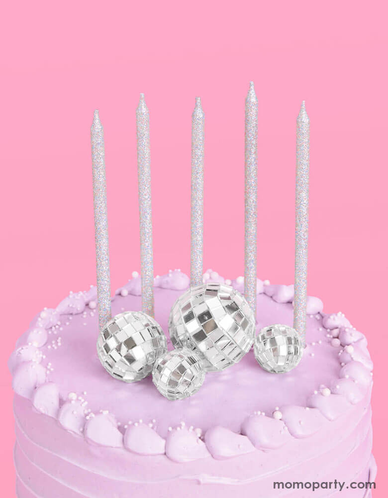The overhead shot of Momopartys's Disco Cake Toppers & five Iridescent Candles on a lilac buttercream birthday cake. This groovy topper and candle set is perfect for a disco themed celebration, a teenage girl's birthday, or a rock star, dace party or even a Taylor Swift themed birthday bash!