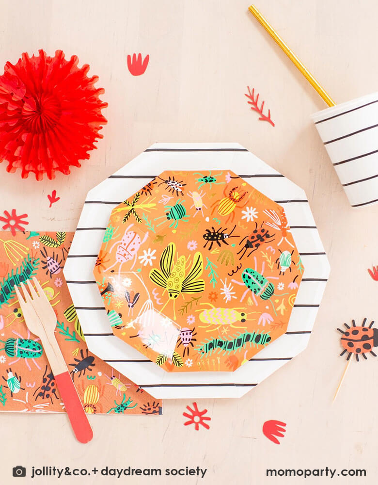 A kid's bug theme birthday party table filled with Momopartys's backyard bug themed party supplies and tableware including plates, napkins and confetti. With neon tone bugs in modern illustrations, these bug themed partyware if perfect for your child's crawling bug inspired party!