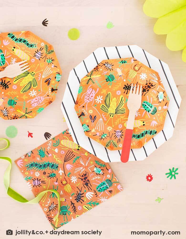 A kid's bug theme birthday party table filled with Momopartys's backyard bug themed party supplies and tableware including plates, napkins and confetti. With neon tone bugs in modern illustrations, these bug themed partyware if perfect for your child's crawling bug inspired party!