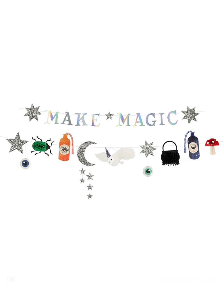 Momo Party's 5.75' Making Magic Party Garland by Meri Meri. It's perfect to hang on walls, in doorways or on the party table. It's also a terrific Halloween party garland. The first garland features the words "Make Magic" with silver holographic foil, and stars covered with chunky silver glitter fabric The second garland features a cauldron, mushroom, beetle and eyeballs with honeycomb details; chunky silver glitter fabric moon and stars; potion bottles with blue and orange yarn; and a 3D flying owl.