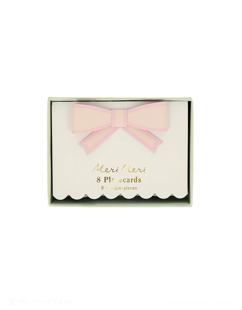 A close up of Momopartys's 3.5"x 2.5" Pastel Bow Place Cards by Meri Meri in its packaging. Featuring pretty pastel colors in 8 different colors, including pale pink, pink, dark pink, ivory, yellow, peach, mint and blue, each of the place card has a 3D paper bow on them, making this an elegant yet darling addition to your tableset.