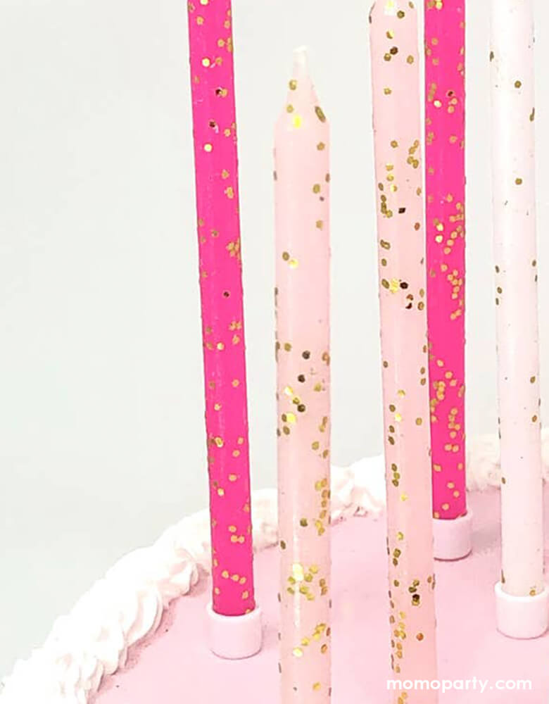 A closer look of the details of Momopartys's Pink Tones Gold Glitter Candle Set by Party Partners. This enchanting set features candles in light pink, hot pink, and white adorned with a touch of gold glitter. Complete with candle holders for seamless placement, these whimsical candles add a magical touch to any event. Ideal for Barbie themed party, princess party or girly celebrations of any kind, these candles bring a touch of elegance and charm.