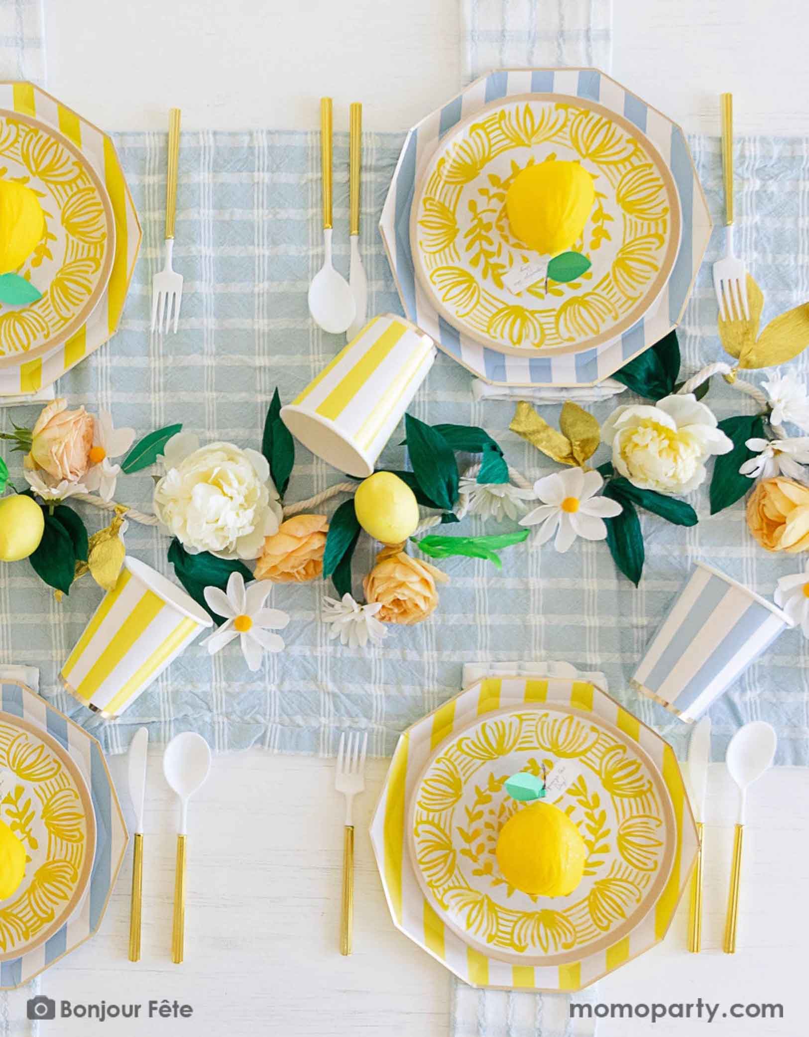 A stunning tableset in a Summer Party Capri Inspired party by Momopartys! Bursting with colors and textures, this stylish setting combines the vibrant striped aesthetics in yellow and sky blue of Capri with the refreshing citrus vibes of lemons and gingham checker patterns. Your guests will be transported to a picturesque seaside Italian village as they enjoy their summer feast underneath these enchanting decorations.