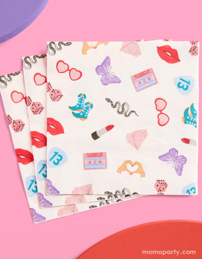 Momo Party's 5" x 5" Taylor Swift Era's Party small napkins Xo, Fetti. Comes in a set of 25 napkins, these napkins have a Taylor Swift inspired motif featuring red lipstick, red lips, butterflies, cowgirl boots, snakes, cassette tapes, guitar picks, heart hand symbols, and heart shaped sunglasses. They're perfect for the party table celebrating your Swiftie girl's special day.