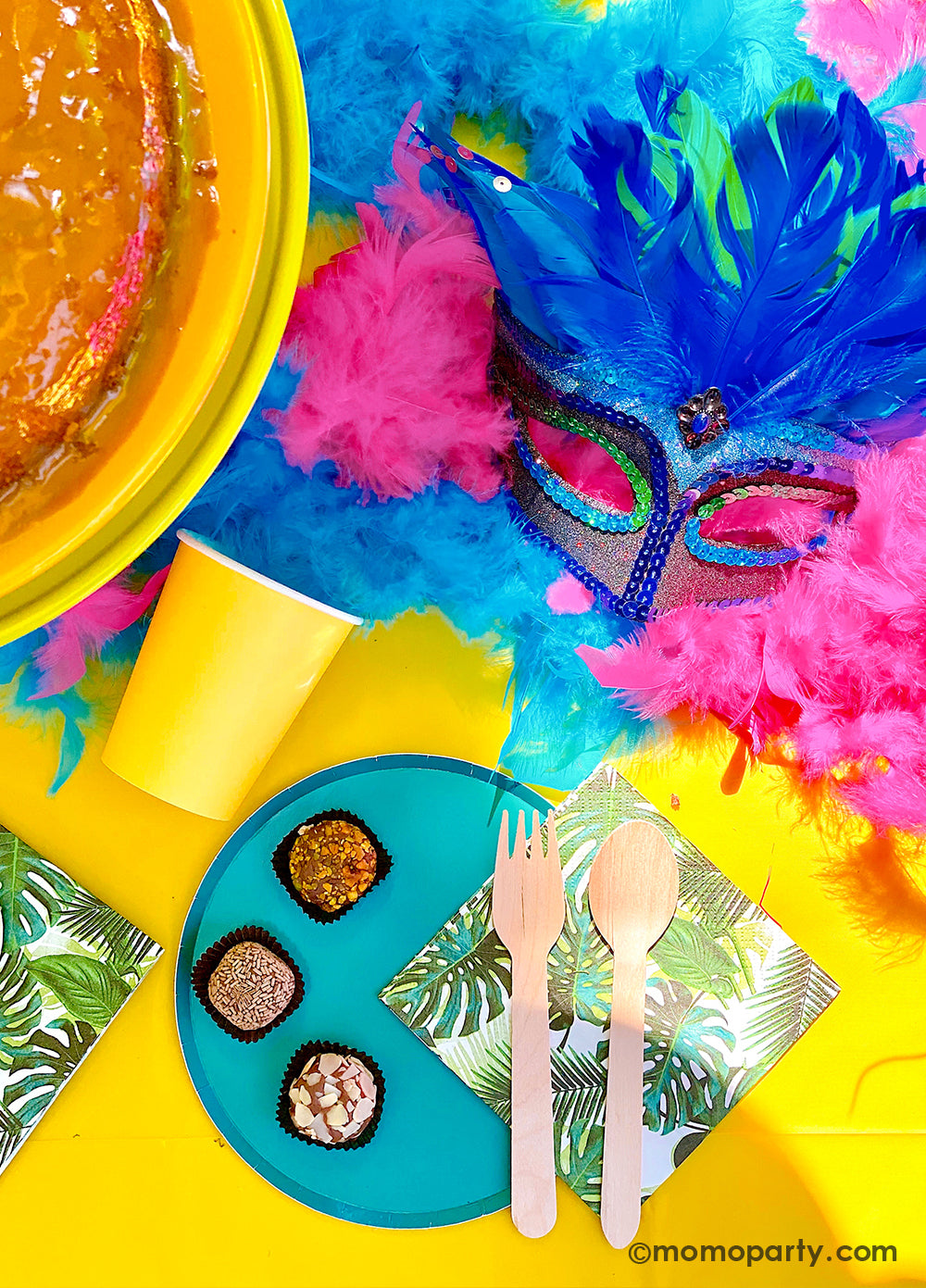 Get ready to throw the ultimate summer celebration with a vibrant Brazilian Carnival-themed party table! Featuring tropical party supplies from Momopartys, this festive setup includes palm leaf napkins, matching plates, and colorful party cups that bring the rainforest vibe to life. Complete the look with feather garlands, carnival masks, decadent chocolate desserts, and a stunning birthday cake. Whether it's for a birthday, summer bash, or themed event, this tropical party setup is perfect for summer!
