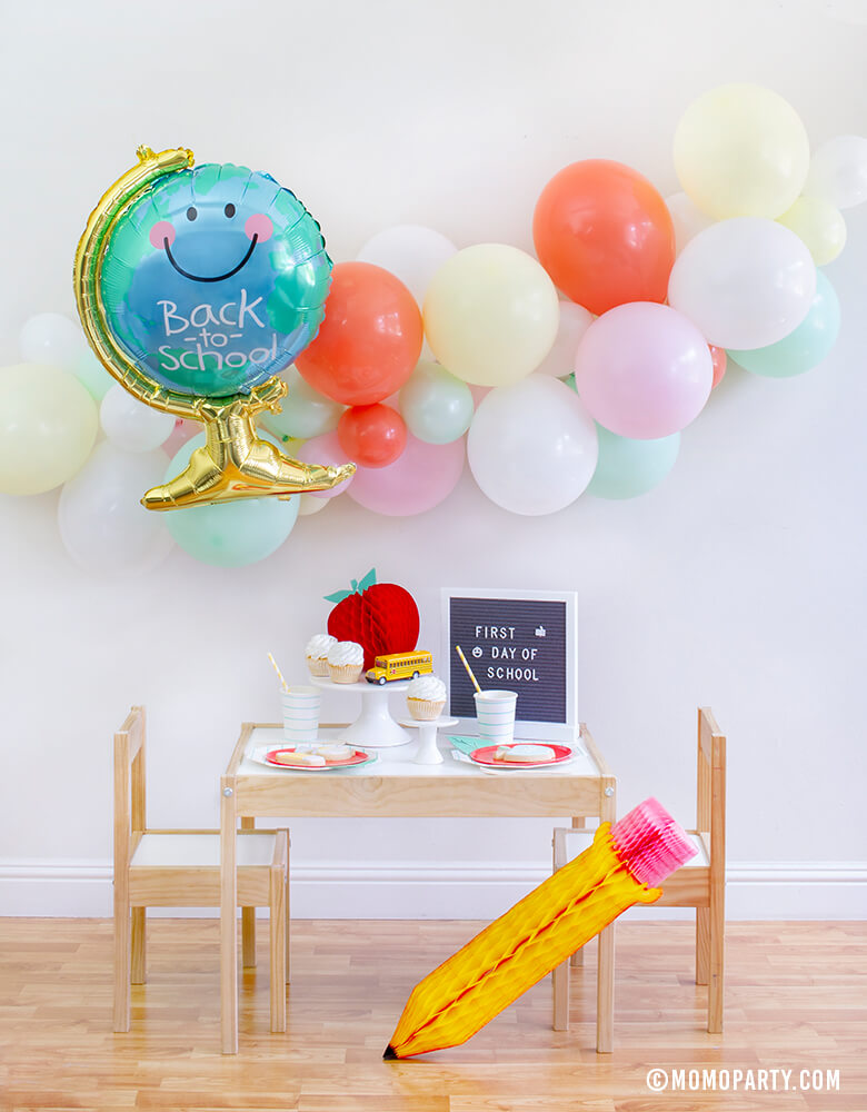 Momopartys Back To School Party Box with Anagram Back To School Globe Foil Mylar Balloon, 6ft long Balloon Garland Assorted in Pastel Yellow, Pink, Mint, Carol, White Latex Balloon for Backdrop decoration, Letter board with "First Day of School" sign, Oh happy day Cherry Red side plate, Aqua Striped Large Plates and cups, Leaf Napkins as tableware, Honeycomb Apple, cupcakes, and school bus toy on cake stand for a Modern Back to school Party Celebration