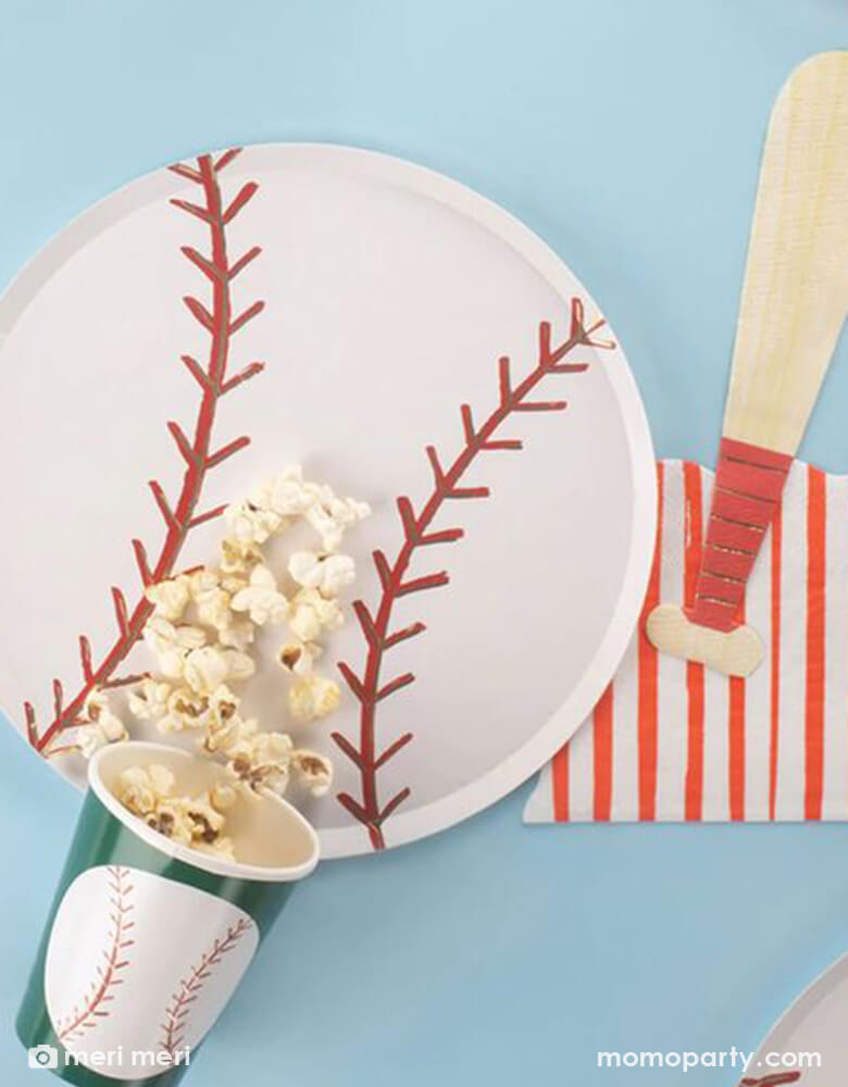 A table set with baseball themed tableware from Momopartys including a 9.5" baseball shaped plate, 4.75 x 7.75" baseball bat shaped napkin and a 9 oz baseball party party cup by Meri Meri. Perfect for kid's baseball themed party or a watch party.