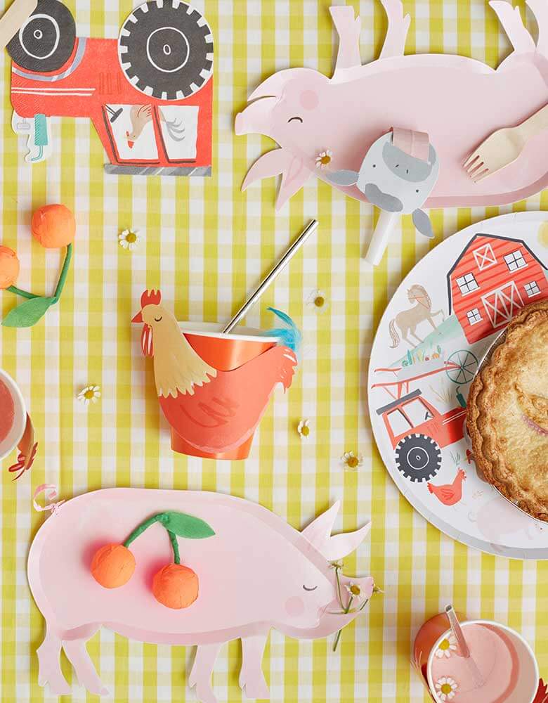 Meri-Meri-On-the-Farm-Collection_featuring farm themed party plates cups and napkins on a yellow gingham tablecloth