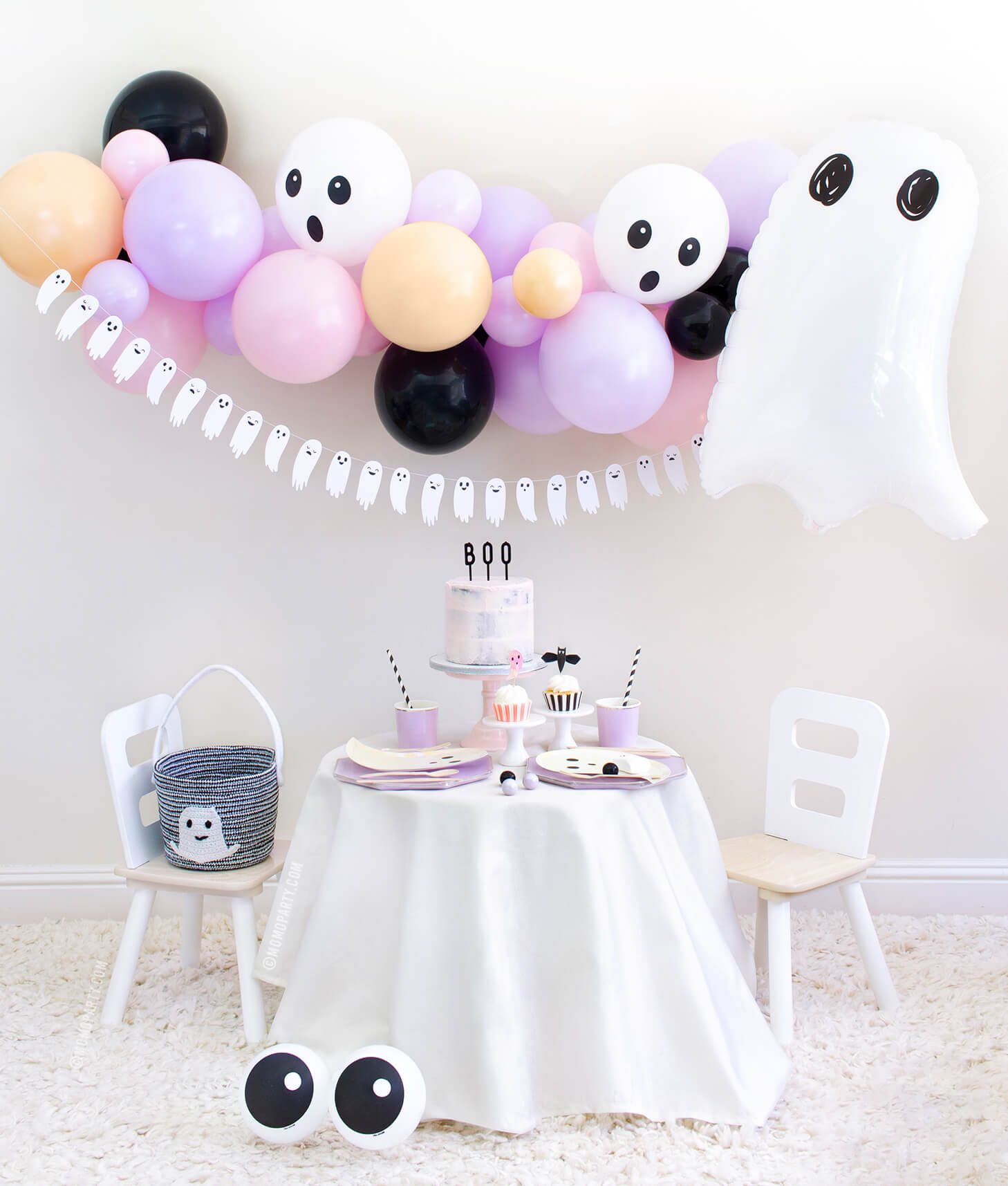 Momopartys 2020 Halloween Boo To You Party Look with: Halloween Ghost Mylar Balloon, Pastel pink and purple balloon garland, Boo To You Ghost Banner as wall decoration, Table set up with Lilac Dinner Plates and Tumbler Cups, Iridescent Ghost Plates, Holographic Ghost Napkins, pink cake with Boo letterboard cake topper, 2 Friendly Eyeball latex Balloons as an eye, Inspire ideas for you Kids Halloween Party, Pink Halloween, Not too Spooky birthday party, Hocus Pocus party, spooktacular halloween party