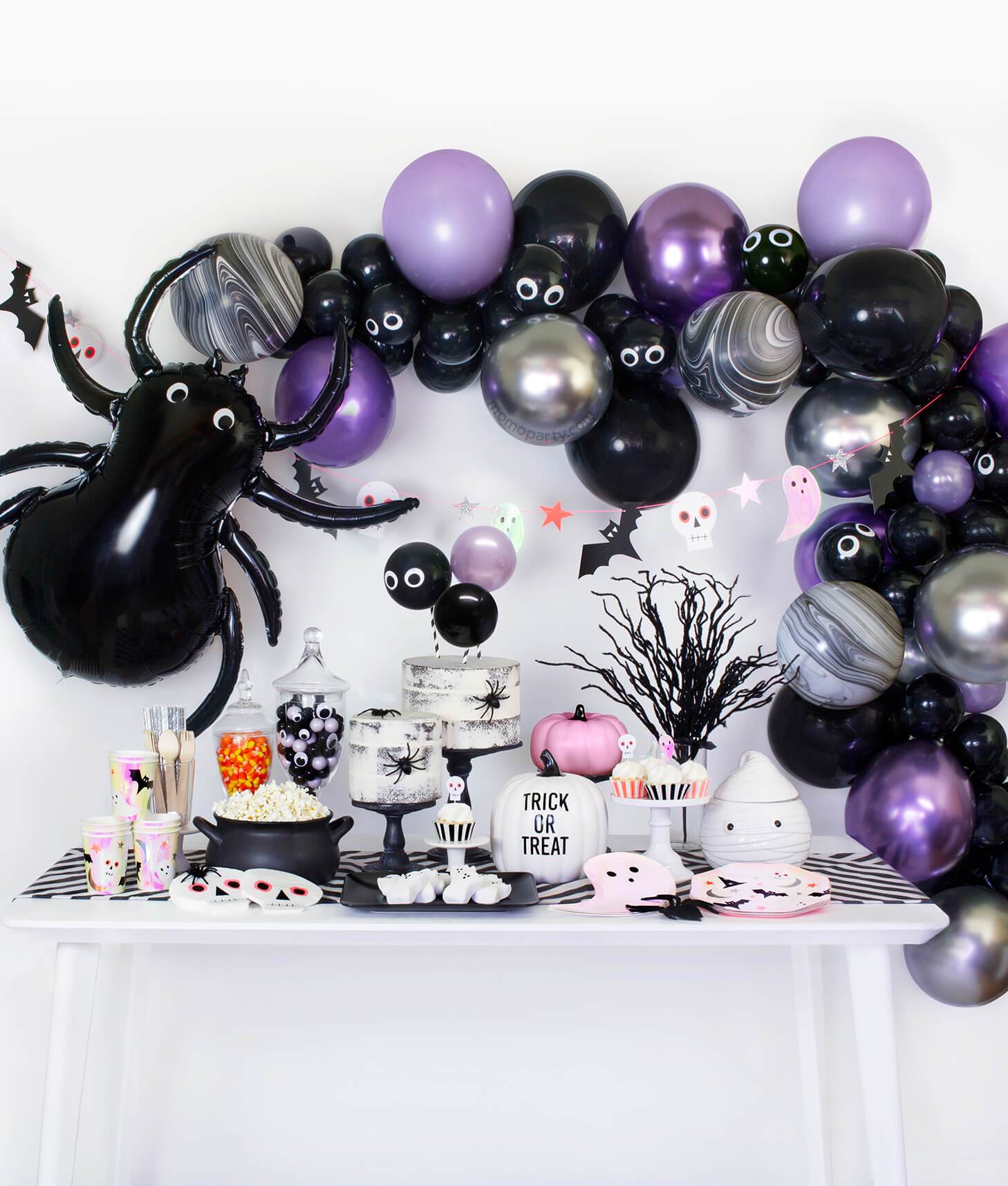 Momopartys Halloween party collection table set up with black, purple chrome and silver color balloon garland, black spider foil balloon decoration