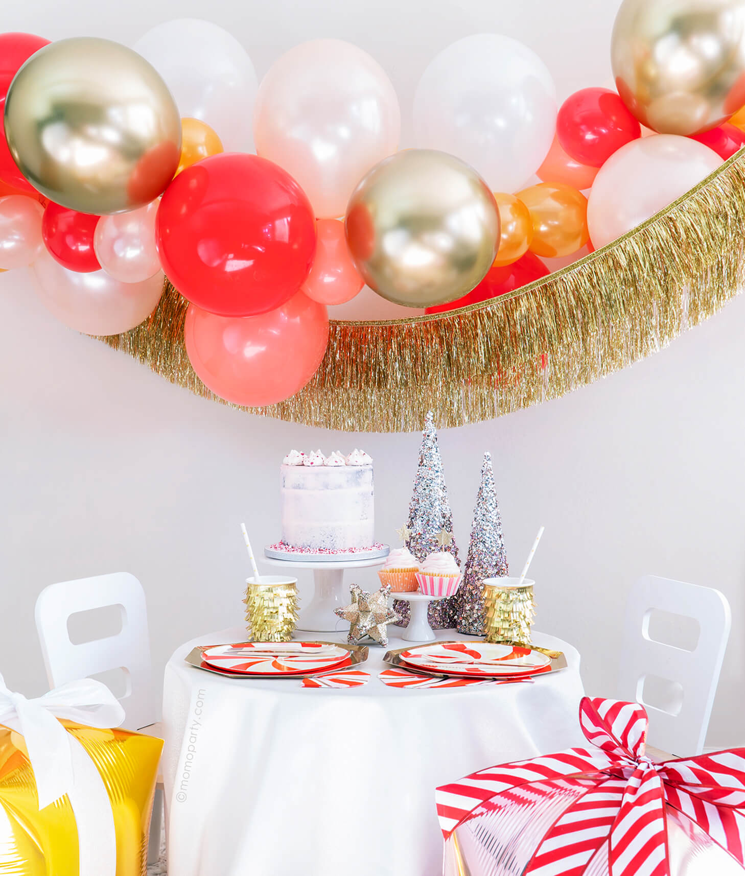 Momopartys Holiday party box - Christmas Candy Cane Glam Holiday Box, Featuring Meri Meri Gold Large Dinner Plates, Peppermint Swirl Side Plates, Gold Fringe Party Cups, Candy Cane Napkins, Silver Wooden Cutlery Set, Gold Star Party Straws, Gold Tinsel Fringe Garland, Candy-cane-glam themed Gold, Red, Pearl White, Coral, Pearl peach latex balloon garland. decorated with your cake, cupcakes, sparking trees for a modern classic cute christmas holiday celebration