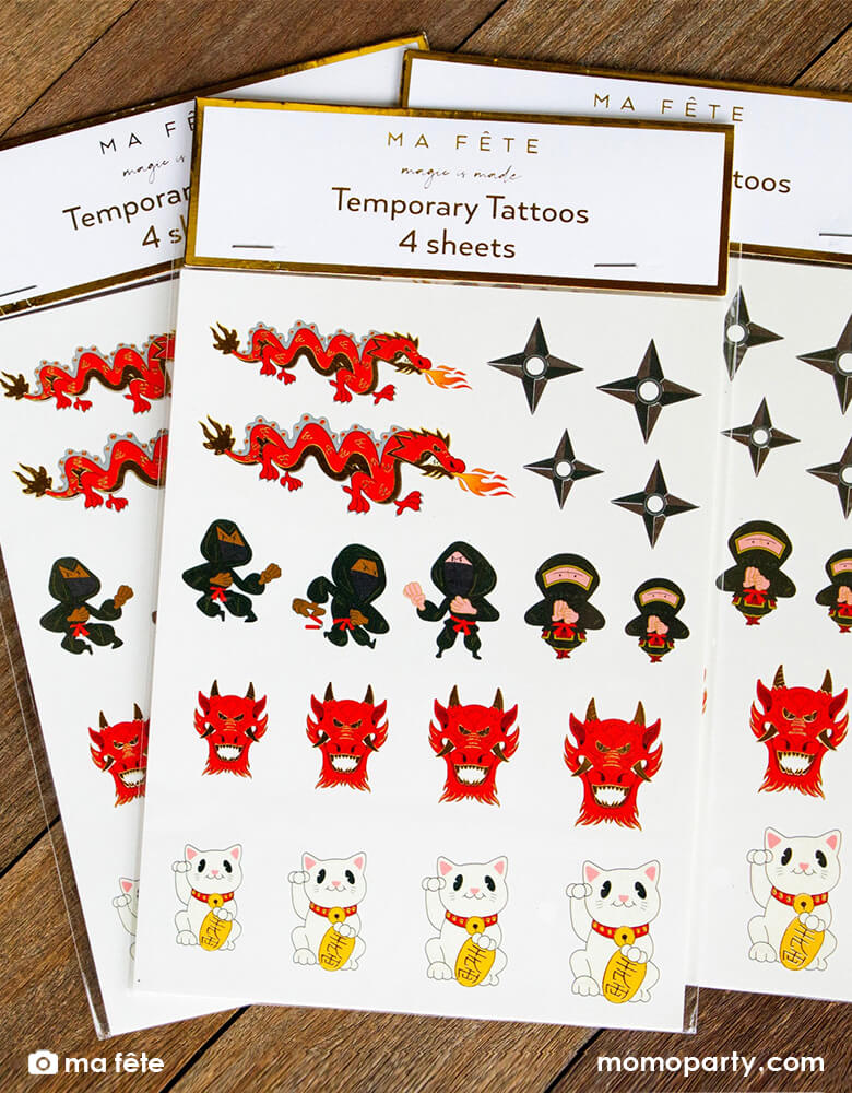 Momo Party's Ninja Temporary Tattoos By Ma Fête. Set of 4 sheets, featuring Dragon, Nijia, Dragon head, ninja darts and Japanese lucky cat designs, These tattoos have gold foil details that look fabulous when worn. Use it as a party gift for your guests at the Ninja themed birthday party, or tattoo away between party activities!