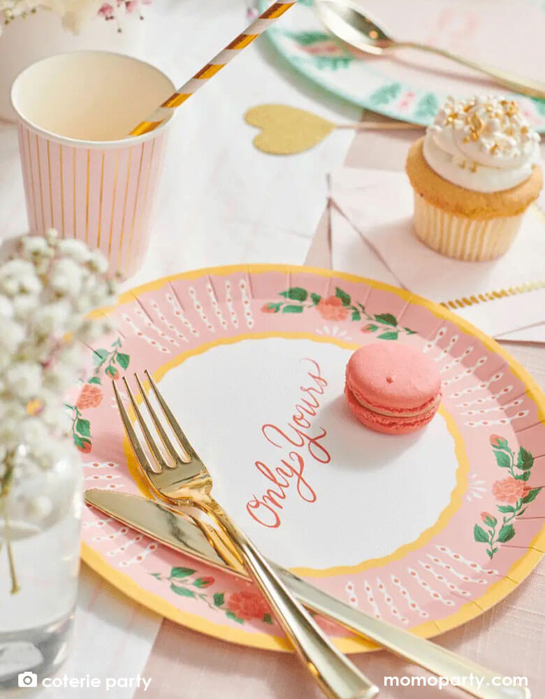 A beautiful love themed party table featuring Momopartys's 9 oz pale pink pinstripe party cups by Coterie Party and 9" All You Need is Love Large Plates with a message of "Only Yours" on the plate. With a table set with pastel pink themed tableware with heart shaped elements, it's a perfect inspiration for a Valentine's Day celebration.