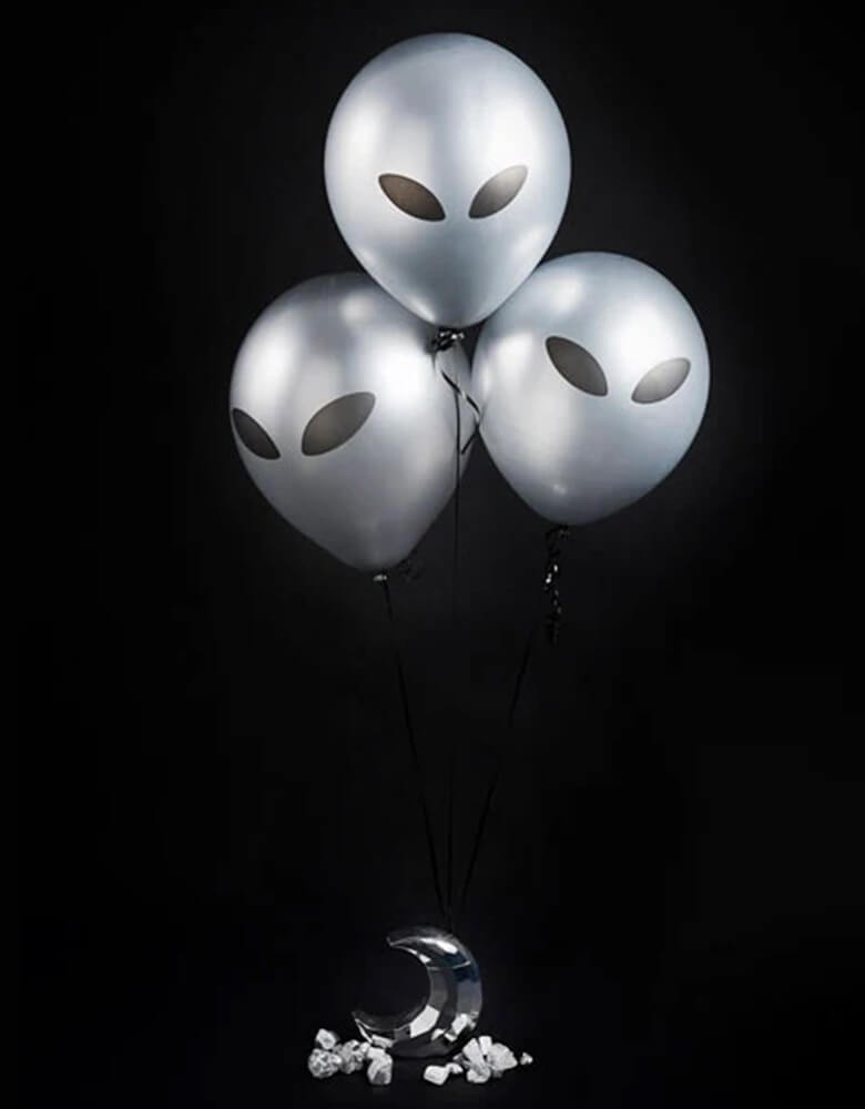 Three of Momopartys's 11" Alien Latex Balloons by Hooty Balloo. These silver alien balloons are a perfect addition to any space theme party! Transform any ordinary party into an out-of-this-world experience with these stellar silver alien balloons! Guaranteed to add a touch of intergalactic charm to your space-themed shindig!