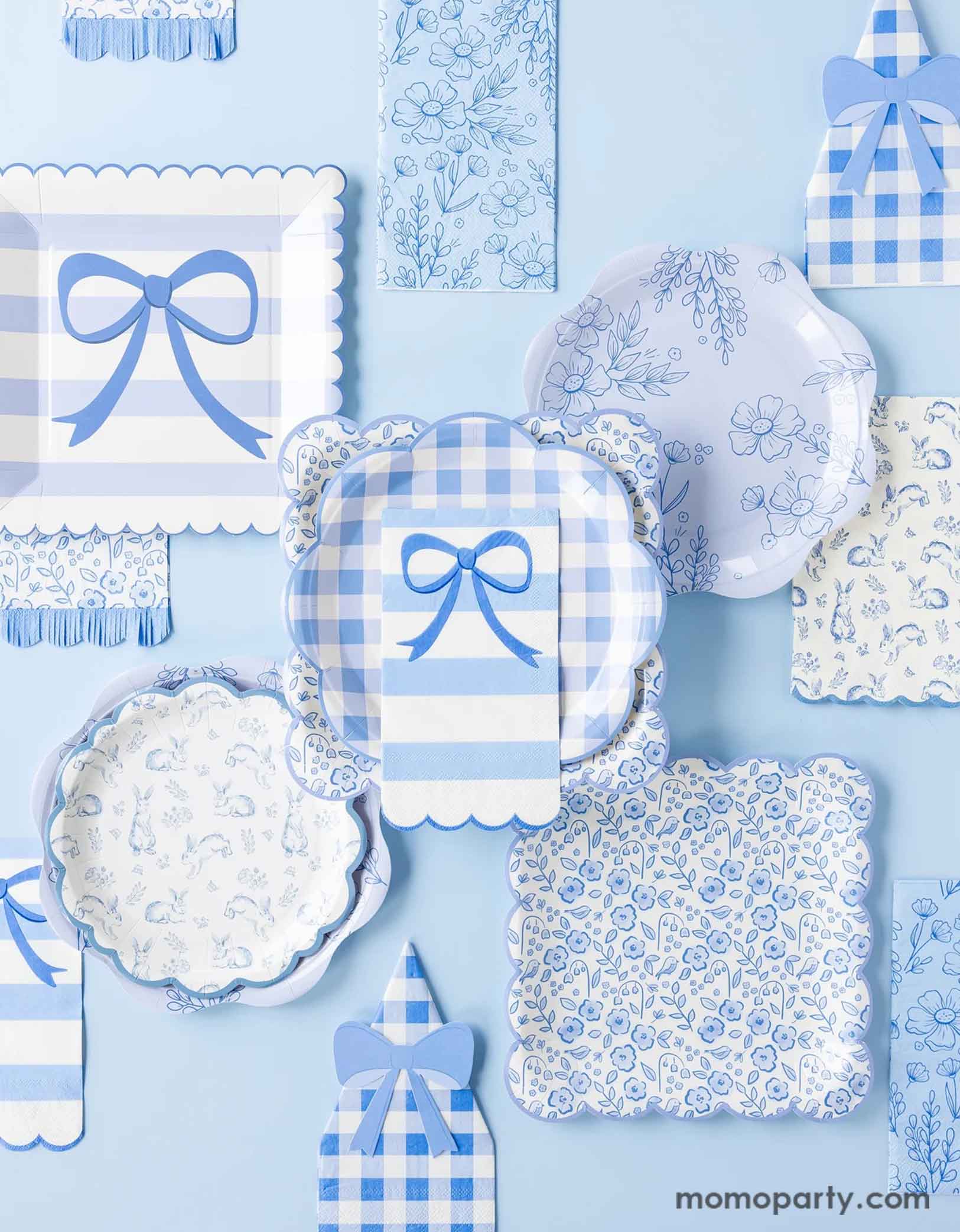 A blue tablescape showcase Momopartys's blue toile & striped bow party tableware collection by My Mind's Eye. Featuring various party plates, napkins in different sizes, shapes and spring inspired shapes including gingham checkered, elegant bows, floral toile, Easter bunny toile, this collection are perfect for your spring gatherings or Easter celebrations!
