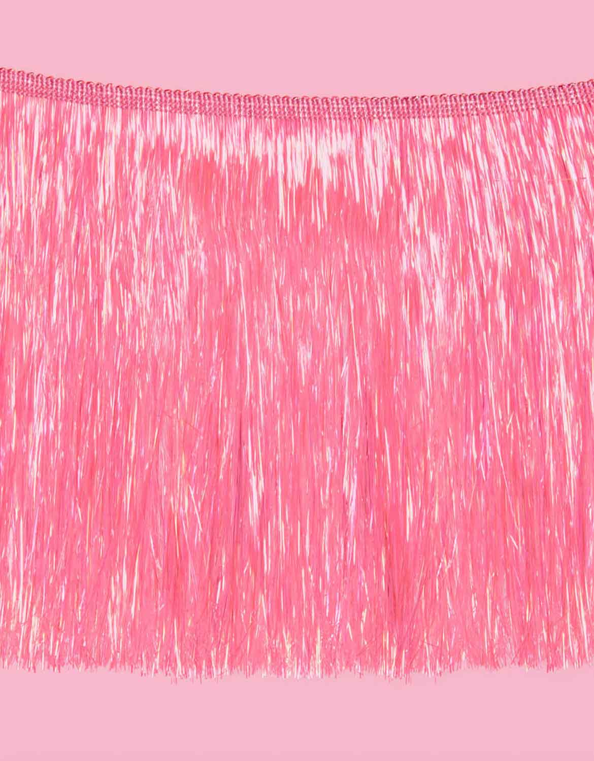 A close up shot of Momopartys's 5 ft Bright Pink Fringe Garland on a pink background.