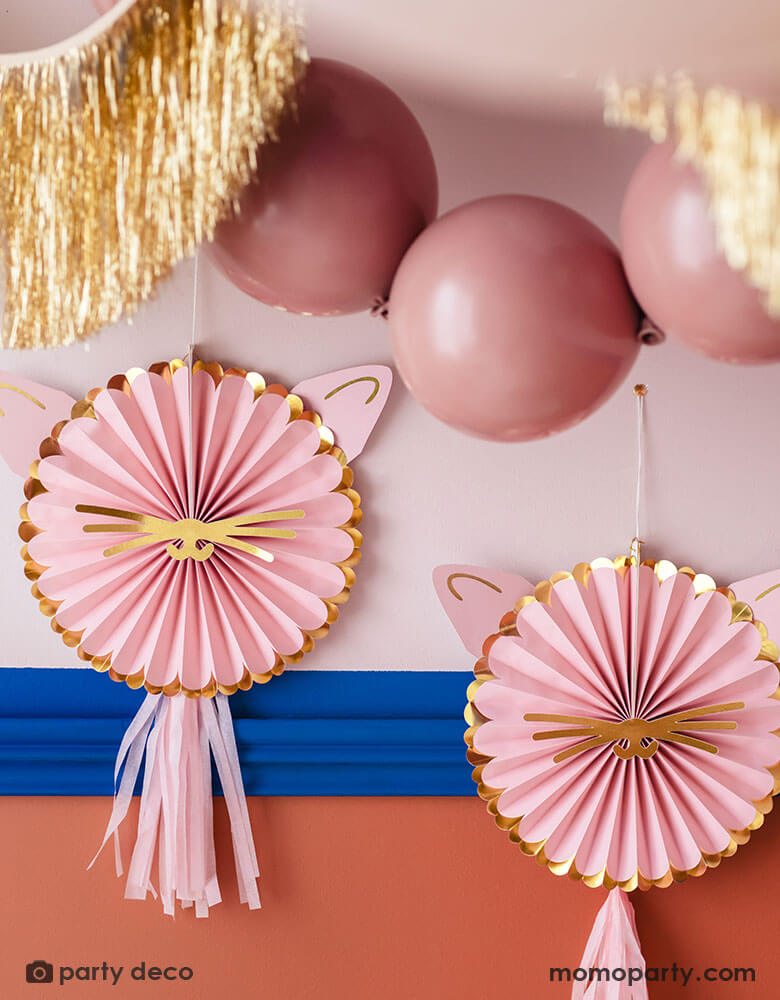 A kitty cat/pet themed party room decorated with Momopartys's pink kitty cat paper party fans, pink party balloons and gold tinsel garland, adding a festive yet modern touch to this celebration. Perfect for kid's pet / cat themed party!