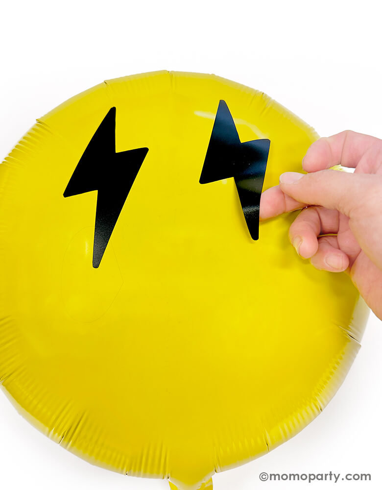 Discover the Cool Dude Smiley Foil Balloon Kit by Momopartys. This kit includes an 18" yellow round foil balloon adorned with lightning bolt eyes and a smiley face vinyl sticker. Simply inflate the round foil balloon and apply the stickers to the center to create a super rad decoration! Perfect for a boy's 'One Happy Dude' themed first birthday, a 'Two Cool' themed second birthday party, 'Ten Rad Years' 10th birthday celebration, or any modern kids birthday party and celebration.