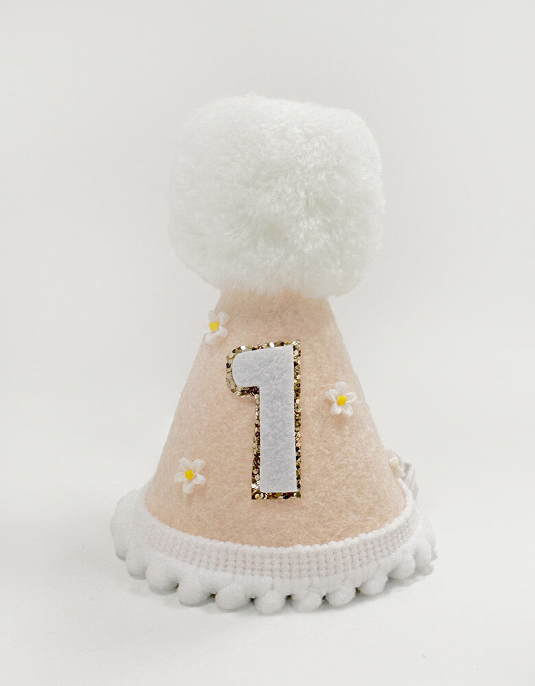 Flower felt first birthday hat for girls from momopartys.shop. Adorned with cute tiny flowers and playful white pom poms and Number one with gold glitter. This peach color felt hat adds the perfect touch of cuteness to any party outfit. A must-have for any girl's special day.