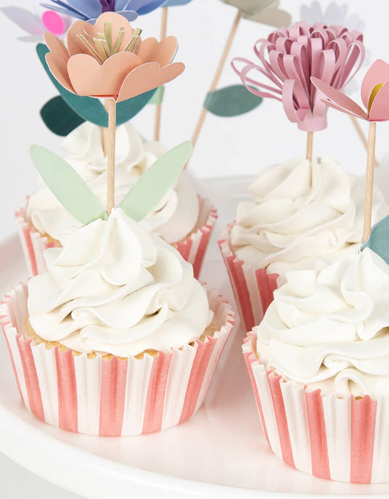 A close up of cupcakes decorated with Momopartys's flower garden cupcake kit which features beautiful hand crafted flowers toppers and striped cupcake cases, this gorgeous cupcake kit is a perfect addition to your spring inspired celebration or garden, floral themed birthday party.