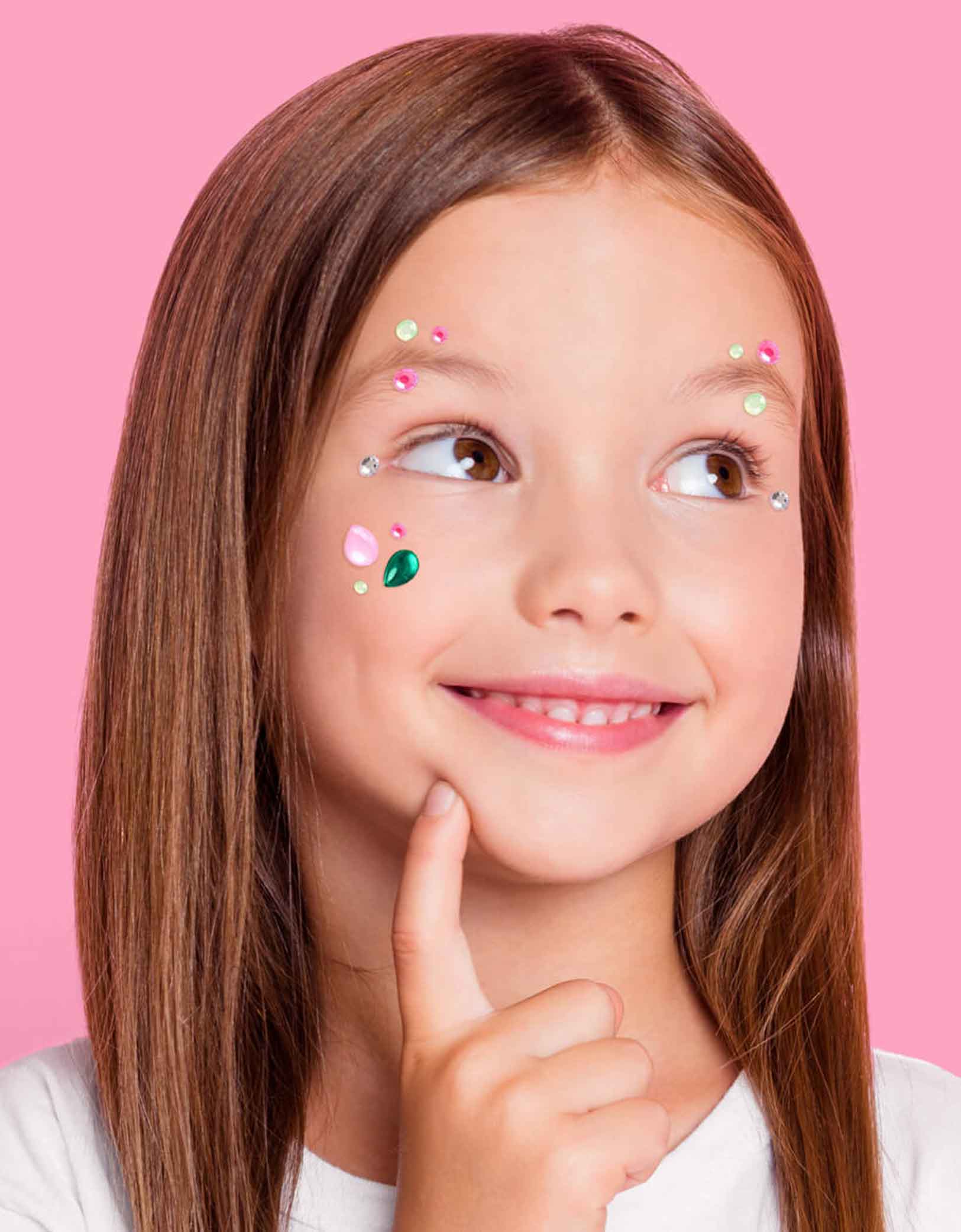 A young girl with Momopartys's Wicked themed gem stickers on her face against a pink background. Perfect for girl's Wicked themed birthday party, witch themed Halloween bash or a magical gathering.