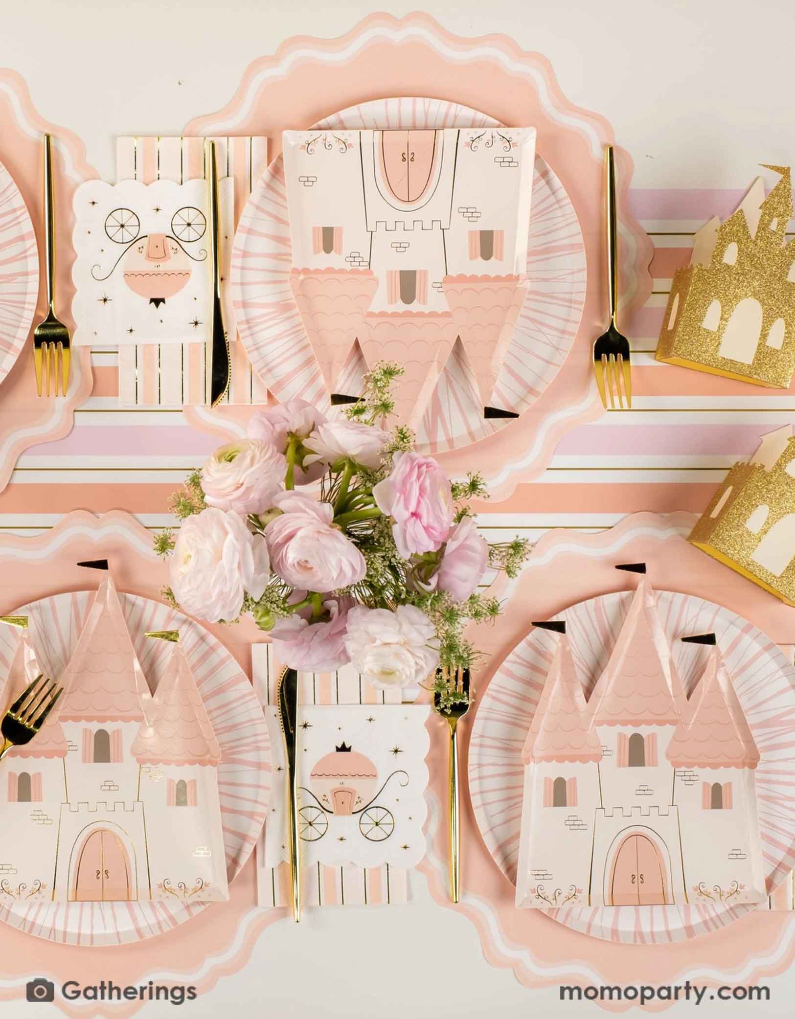 A beautiful princess themed table setting with the castle shaped plates, princess carriage small napkin, gold cutlery, castle shaped treat boxes and the pink and gold striped table runner from Momopartys. With a beautiful floral bouquet on the table, this creates a fairy tale tablescape for a girl's princess themed birthday party.