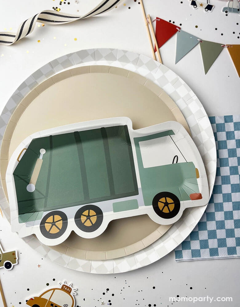 A festive kid's construction themed party tablescape featuring Momopartys's 10.25" light grey checkered dinner plate, 9" beige large plate and a green garbage truck shaped paper plate by Josi James. Around the party plates are blue checkered paper napkins, birthday cake pennant flag topper, and vehicle themed cupcake toppers, along with some confetti, this makes a great inspiration for a preschool boy's birthday party decoration!