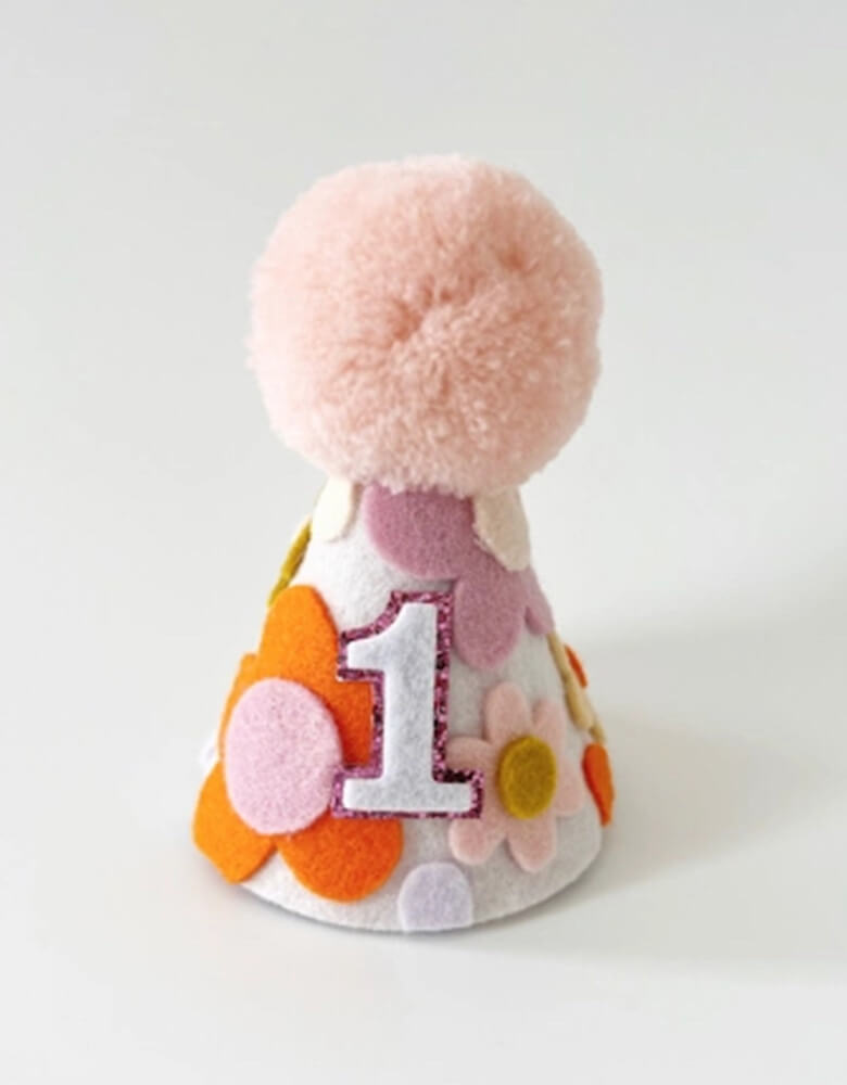 Groovy One Felt First Birthday Hat for girls from momopartys.shop. Adorn with felt handcut daisies in retro inspired colors, this birthday hat adds the perfect touch of cuteness to any party outfit. A must-have for your girl's "One Groovy Baby" themed first birthday!