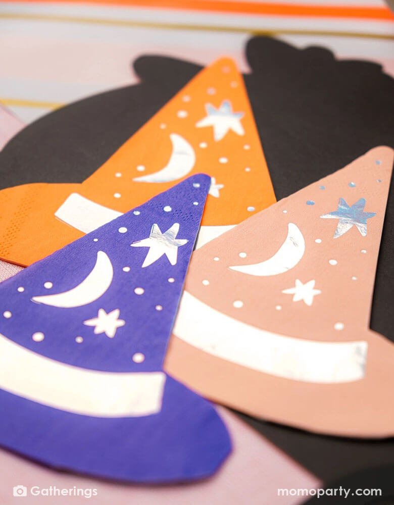 A close-up shot of Momopartys's 5.5" Bewitching Hat Shaped Napkins by Gatherings. Featuring intricately designed witch hats, these napkins will charm your guests and elevate your Halloween celebrations. Get ready to brew up some fun and create a bewitching atmosphere with these napkins.