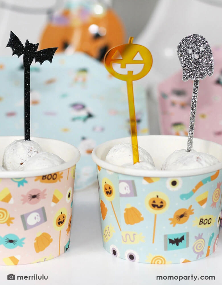 A couple of Halloween snack cups filled with donut walls topped with Momopartys's Halloween Monsters Mash acrylic food picks which feature a skull, a bat, a pumpkin and a ghost. They're perfect for kid's friendly Halloween celebration, a trick or treat party or a Halloween boothday!