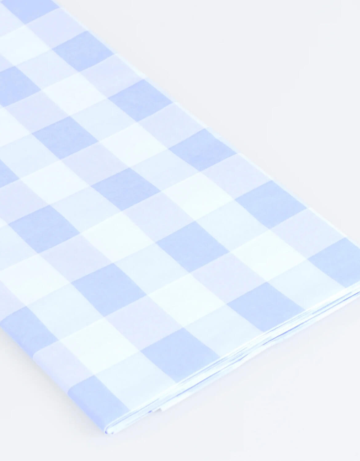 A close up of Momopartys's paper tablecloth with blue and white checkered design by Meri Meri on a white background.