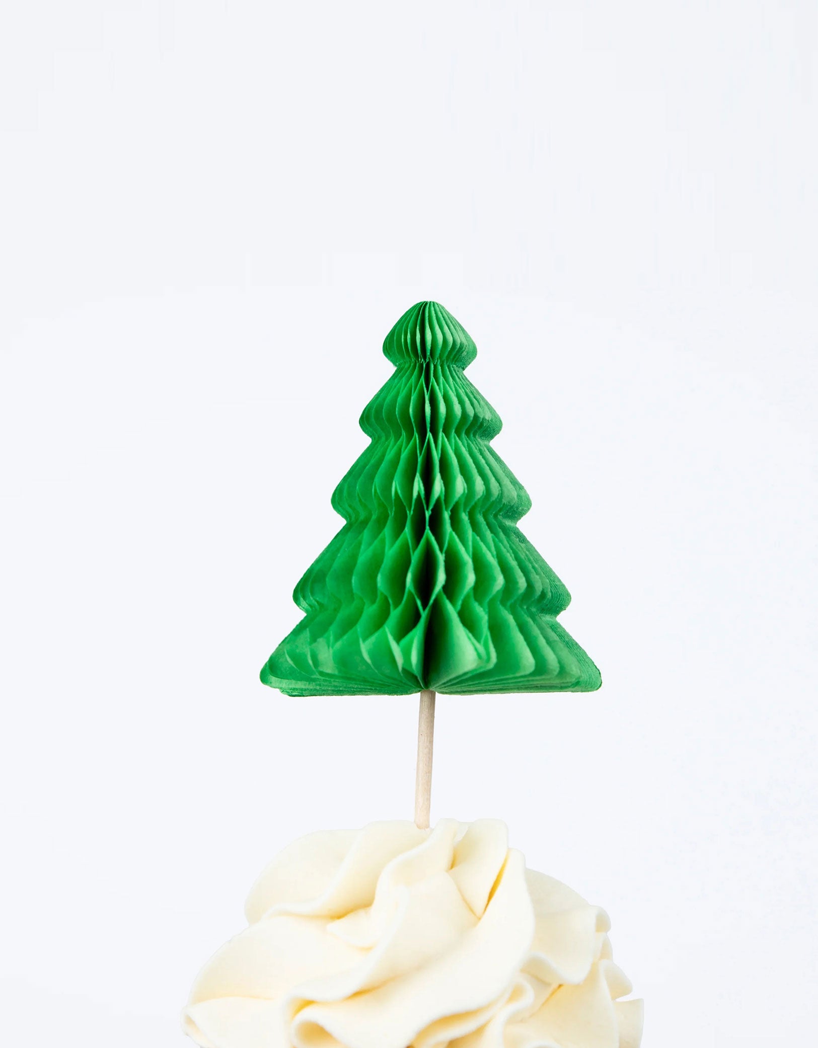 A close up shot of Momopartys's Camping Adventure Cupcake Kit by Meri Meri. This kit includes cake toppers with iconic camping characters and retro designs, teamed with checked cupcake cases. This specific cupcake topper features a honeycomb tree with a wooden cocktail sticks to easily insert the toppers into your cupcakes.
