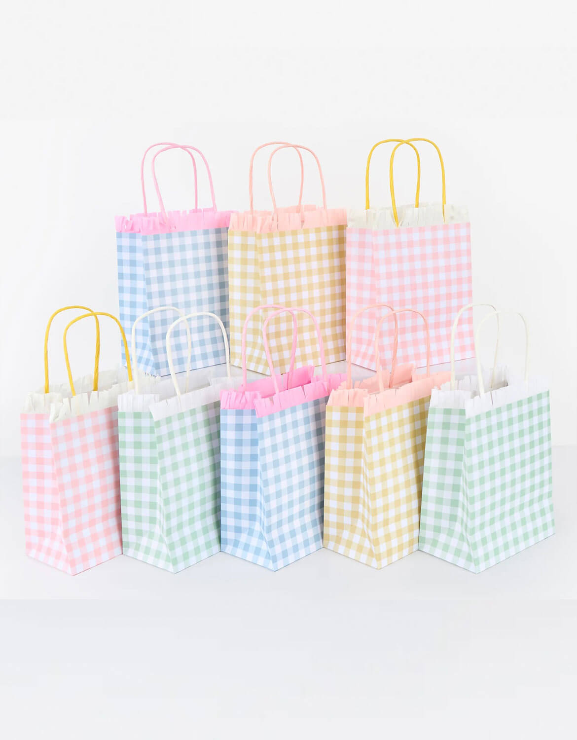 A set of Momopartys's party bags with pastel gingham patterns in four color by Meri Meri on a white background.