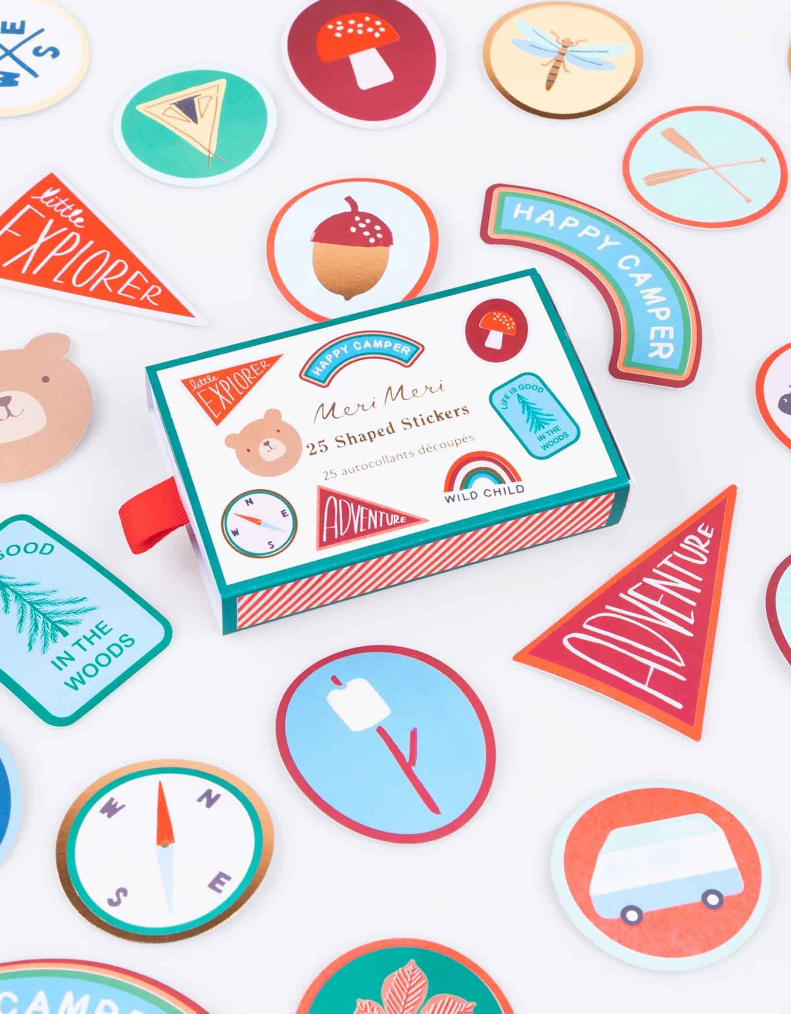 Momo Party's Outdoor Adventures Shaped Stickers by Meri Meri. Comes in a set of 25 stickers with 20 designs that are inspired by camping activities including compass, camping van, acorn, paddles, bear, natural park patches and more,  these special camping themed shaped stickers, with fun retro summer-camp inspired icons are perfect for kid's craft activities, or pop into party bags for hours of imaginative play!