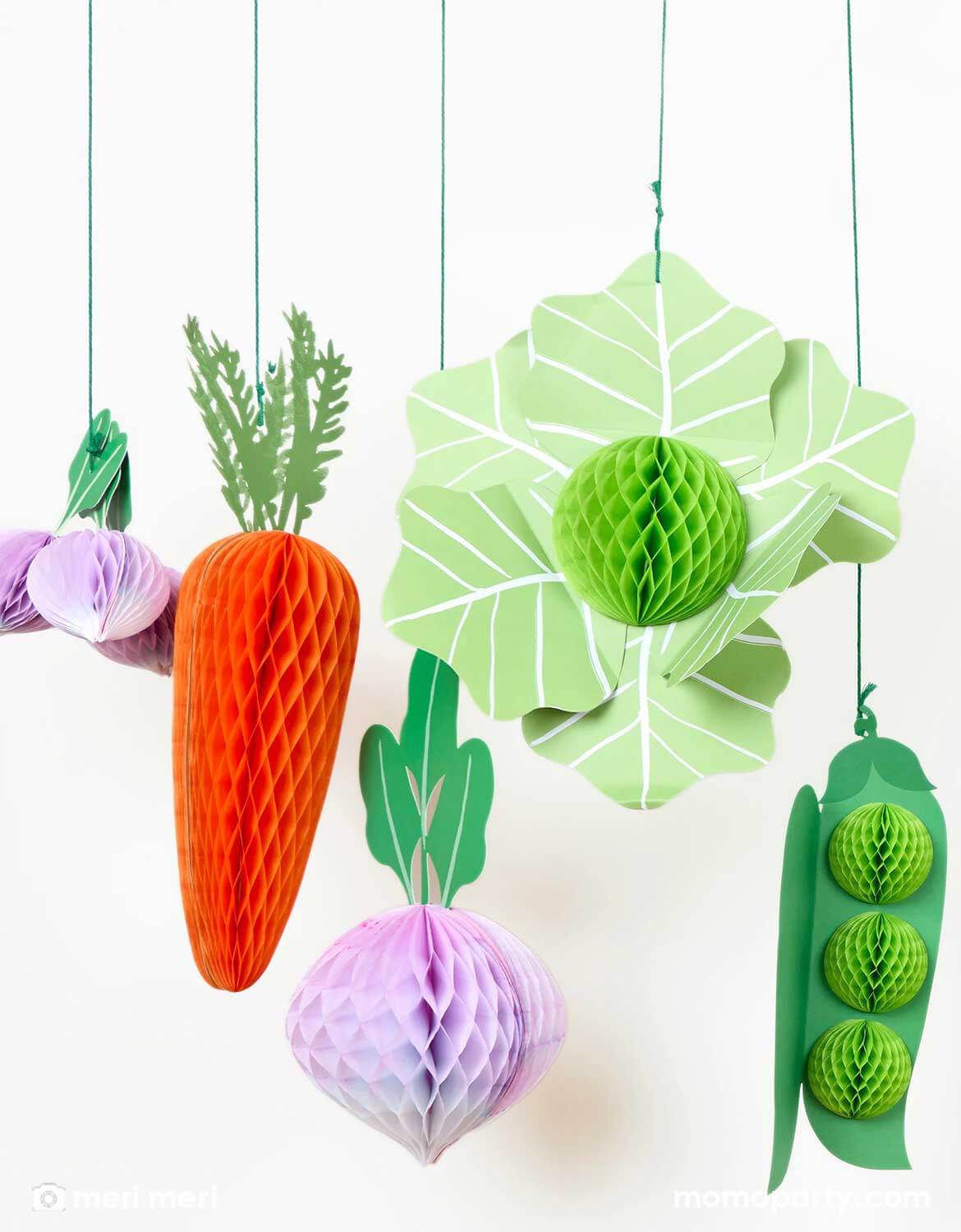 A set of Momopartys's decorative paper hanging vegetable honeycomb decorations by Meri Meri including a carrot, green peas, a lettuce and beets on a white background.