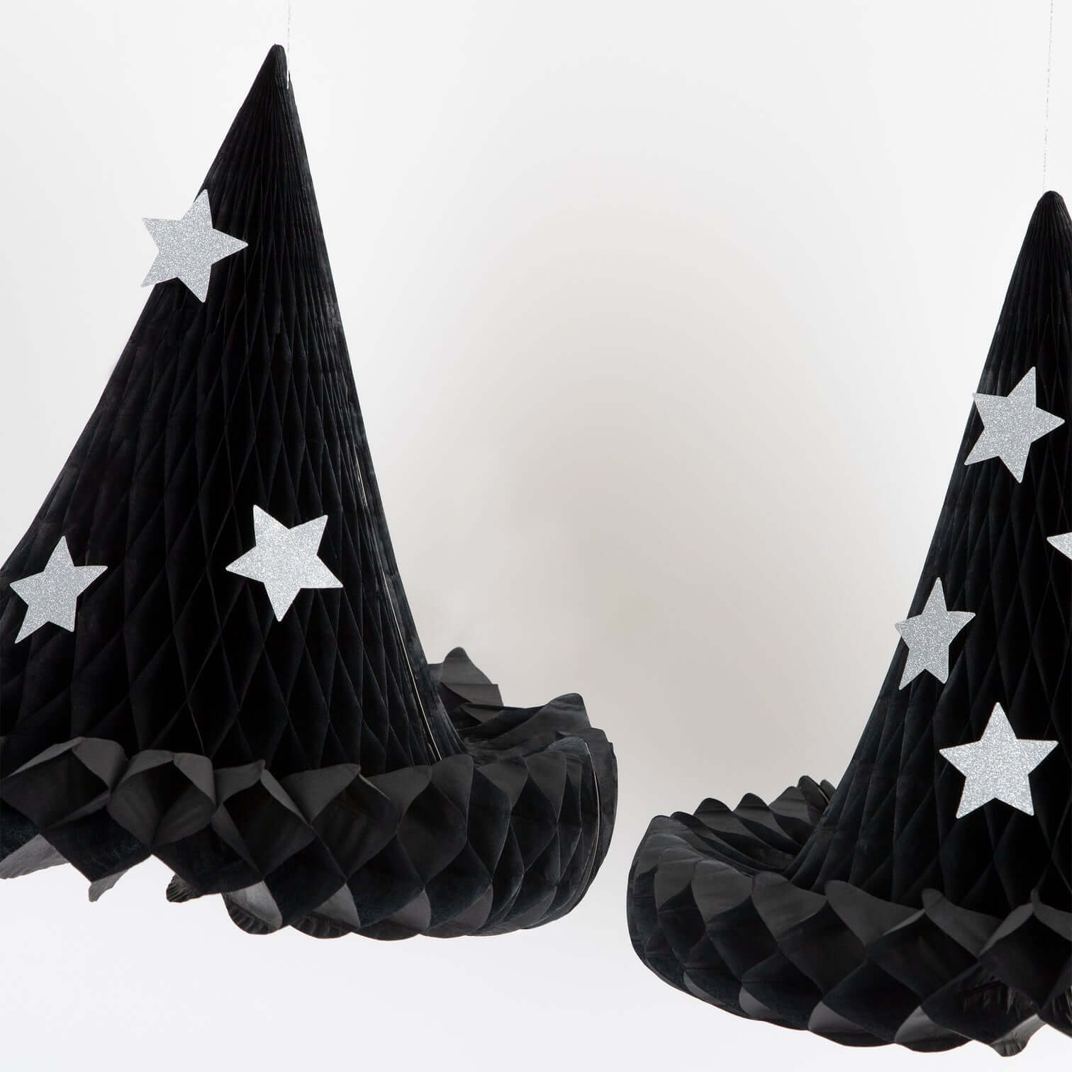 Meri Meri Hanging Honeycomb Witch Hat Decorations, Sale by Momopartys. This 13.25" x 12.875" Witch Hat Hanging Decorations made by tissue paper honeycomb witch hats, with silver paper clips to hold them open. Whether they are hanging in your home, or gently swaying in your porch or garden, these versatile witch hats will delight all visitors on Halloween.  The glitter stars will shine brightly to mesmerize your guests too.