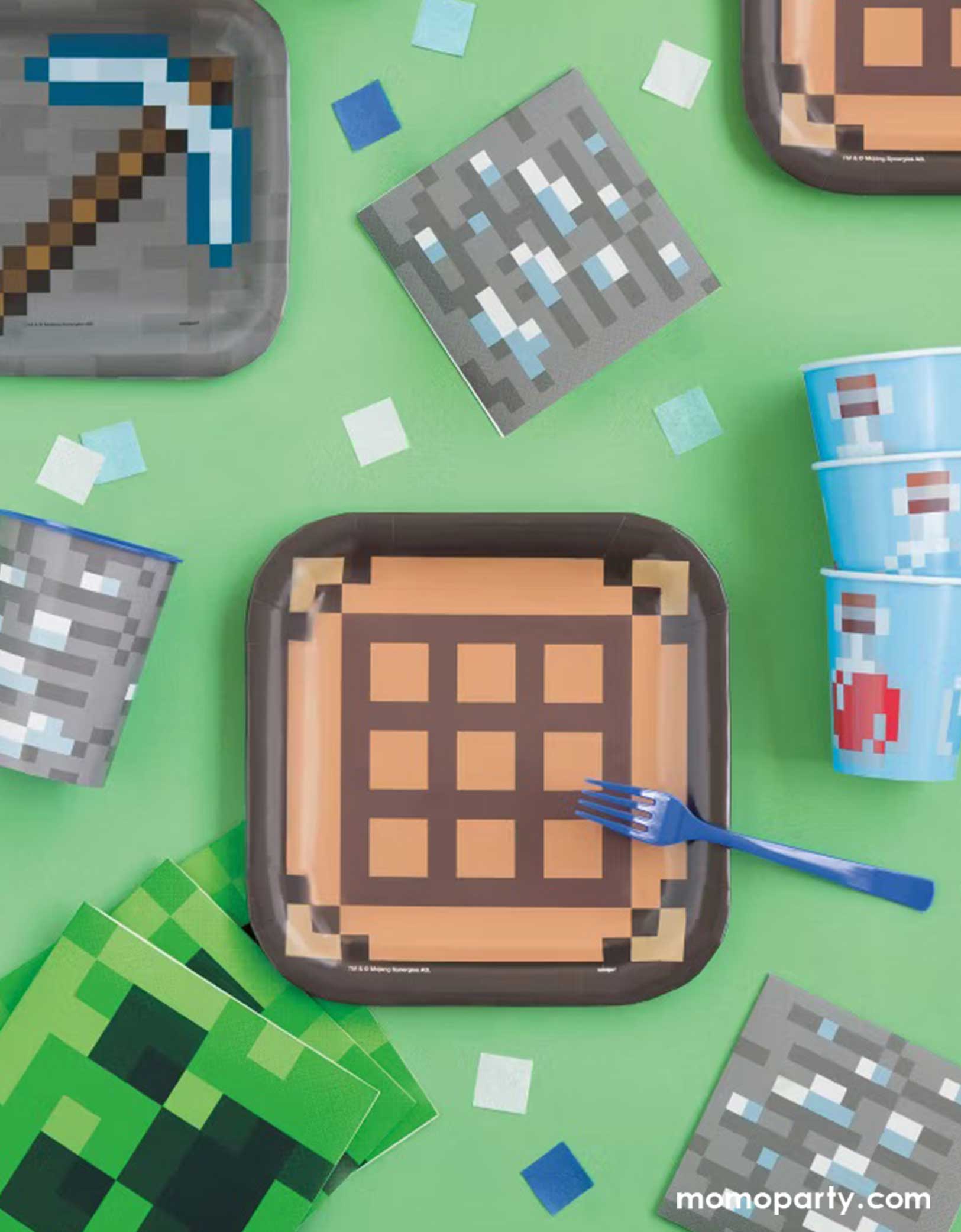 A green kid's Minecraft themed birthday party table featuring Momopartys's Minecraft themed party tableware including 8" brown and black brick paper plates, the 7" pickaxe paper dessert plates, Creeper napkins, gray brick napkins and blue pixelbomb paper cups, making this a fun and great party collection for kid's Minecraft themed birthday celebration!