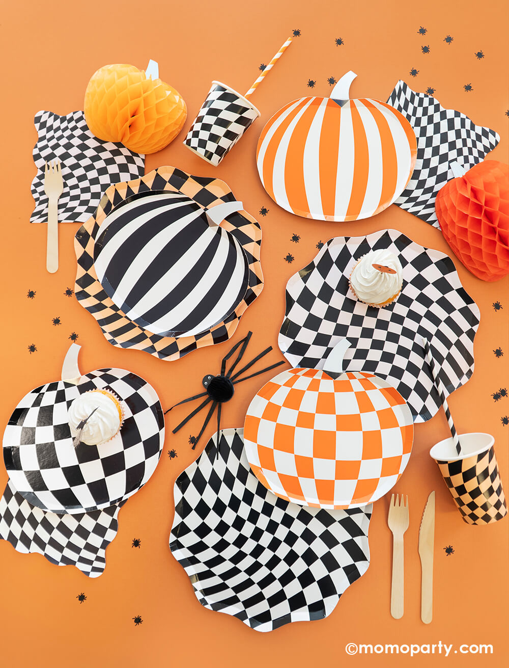 A classic Halloween orange and black party table by Momopartys featuring swirl checkered plates, napkins and cups by Meri Meri, along with mod and stripe patterned pumpkin shaped plates in black and orange. Makes it a classic Halloween look for a spooky fun Halloween bash!
