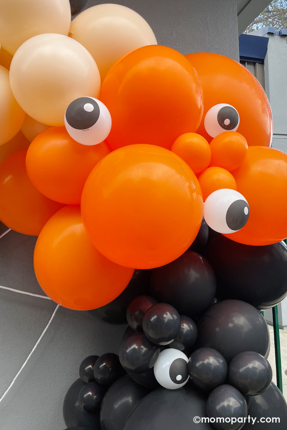 Halloween balloons by Momopartys in orange, blush, and black with qualatex' 5" eyeball balloons, it creates a spooky yet adorable decoration for kid's Halloween themed party or trick-or-treat celebration.