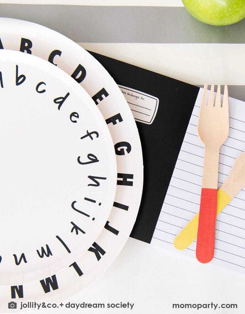 A close up of Momopartys's school days ABC large and small plates by Daydream Society. Along with the notebook invitation and color dipped wooden utensils, this makes a great inspiration for a school themed celebration.