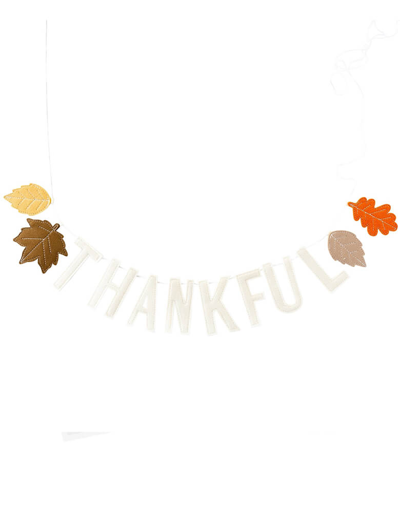 Momopartys "Thankful" felt puffy banner with leaves by My Mind's Eye. Celebrate your gratitude this Thanksgiving with this thankful felt banner. Featuring colorful fall leaves and felt letters that spell the sentiment "thankful," this banner is the perfect addition to your decor this November!