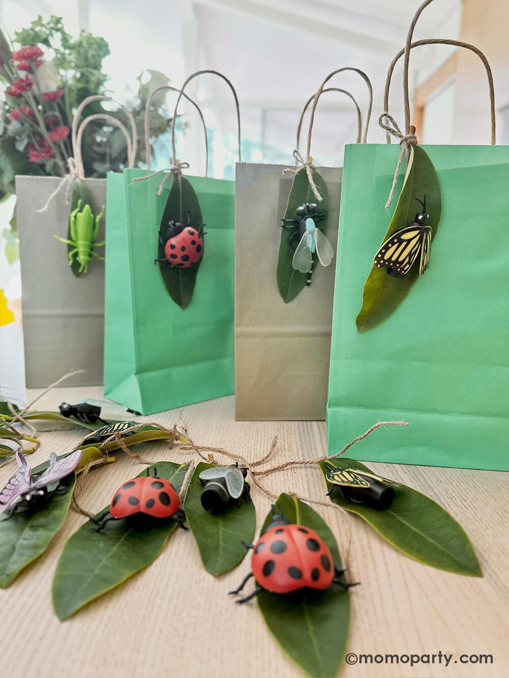 A diy project using Momopartys's various insect finger puppets and real leaves as decoration to party favor bags for kid's bug insect themed birthday party.