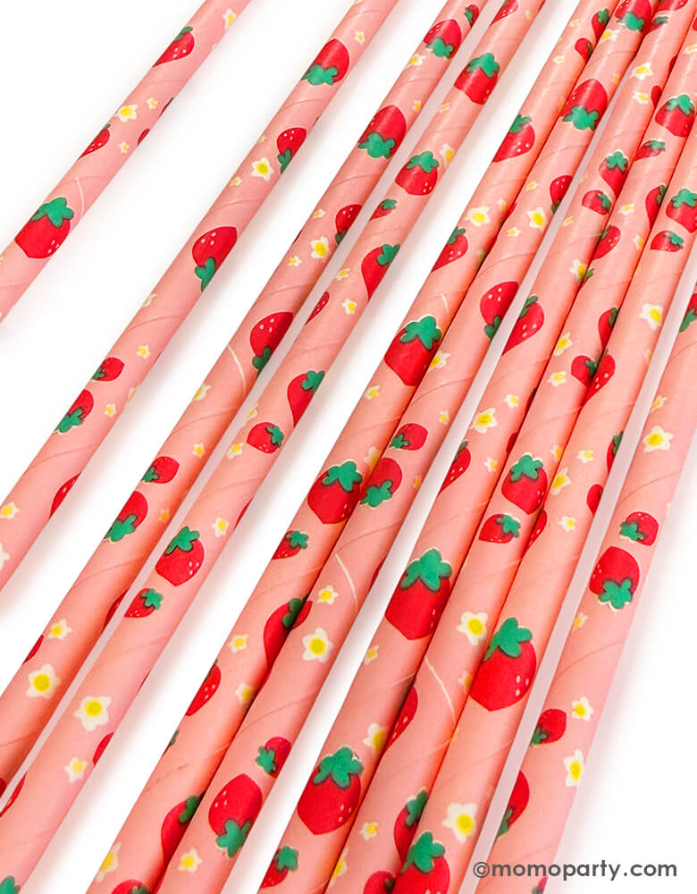 Close up of Momopartys's eco friendly disposable paper party straws with Strawberries and yellow flowers pattern on a white background.