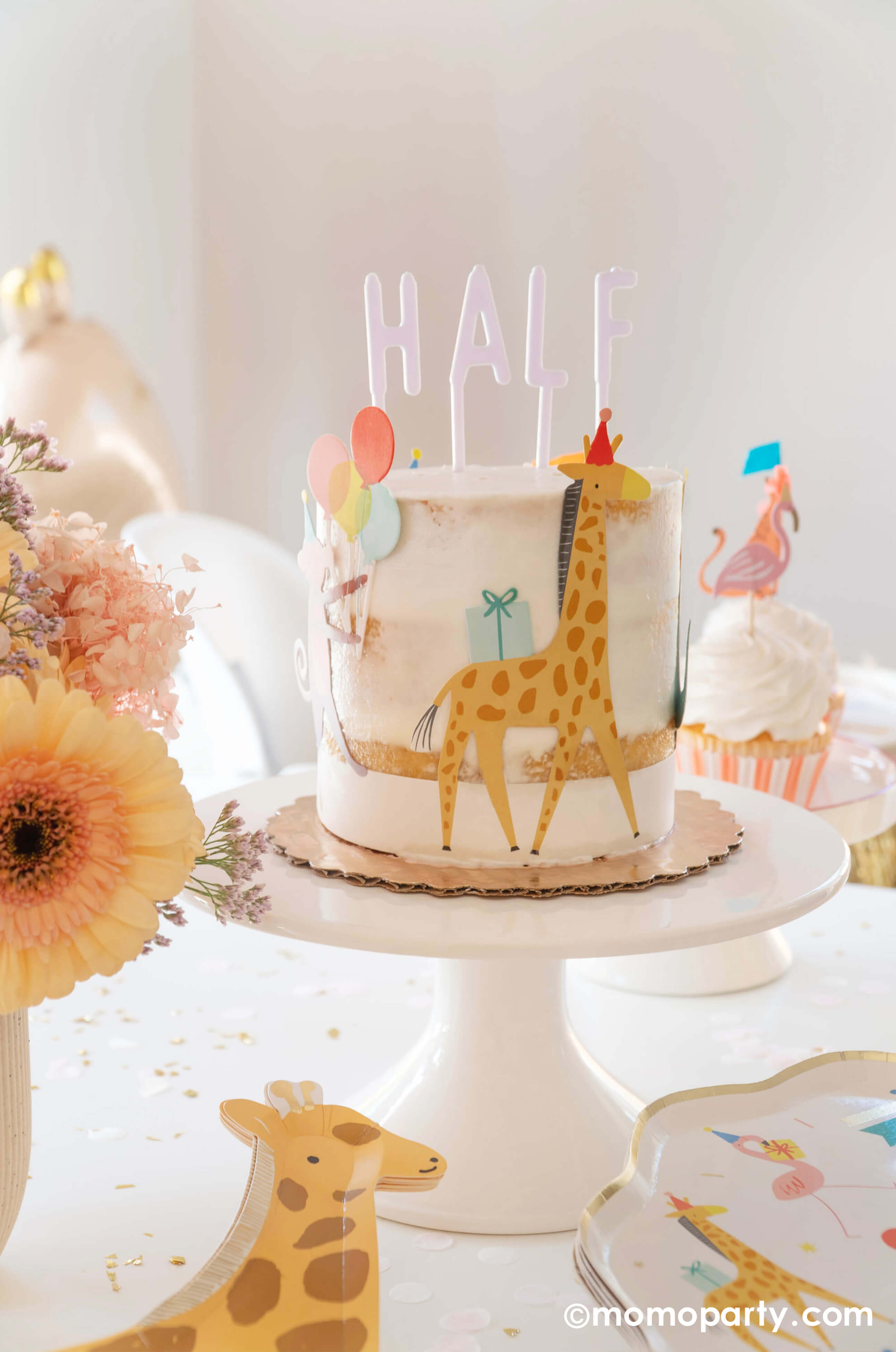 Momopartys hosted A kid's animal themed party table, with a Naked Cake decorated with Meri Meri Animal Parade Cake Wrap & Toppers, which featuring a giraffe with party hat, and on the top spelling "HALF" with Cake By Courtney Letter-board Cake Toppers, repersend for a six months half birthday, along with Meri Meri Animal Parade Dinner plate, Meri Meri giraffe shaped plates, fresh flower arrangement, it makes a great party inspiration for kid's animal, safari, carnival themed birthday party.
