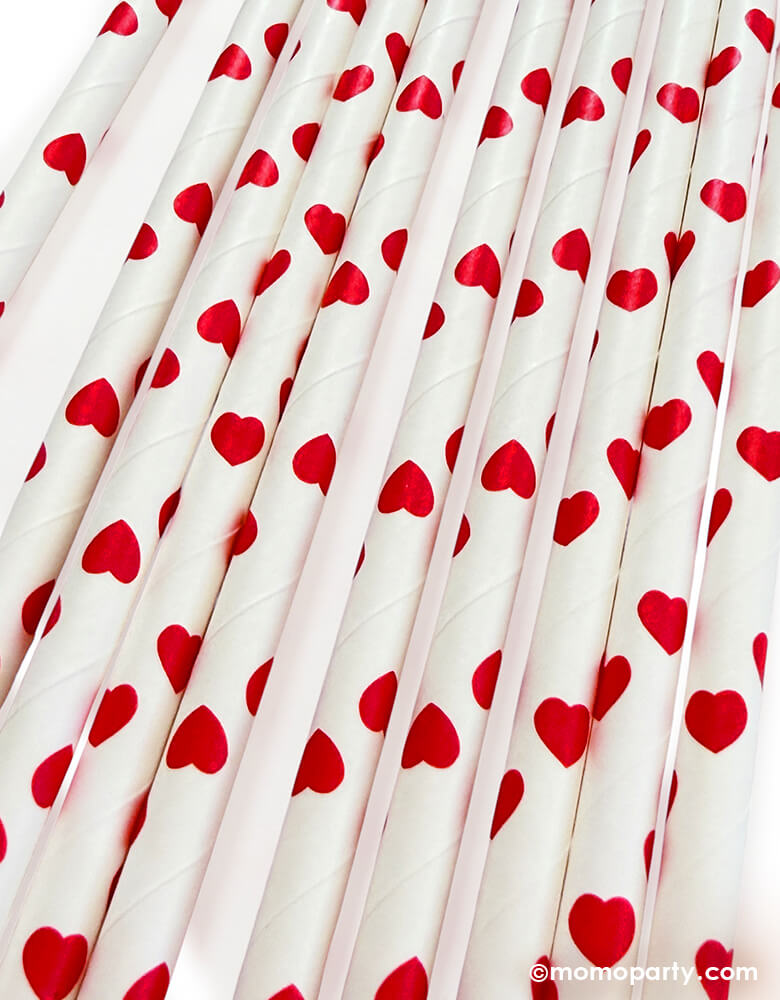 close up of Momopartys's eco friendly disposable paper party straws with red hearts pattern on a white background.